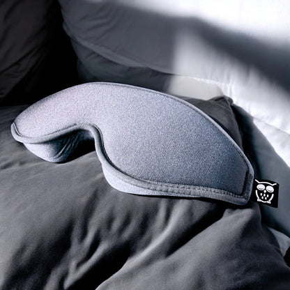 Deep Sleeps 100% Blackout Sleep Mask - grey on white pillow
